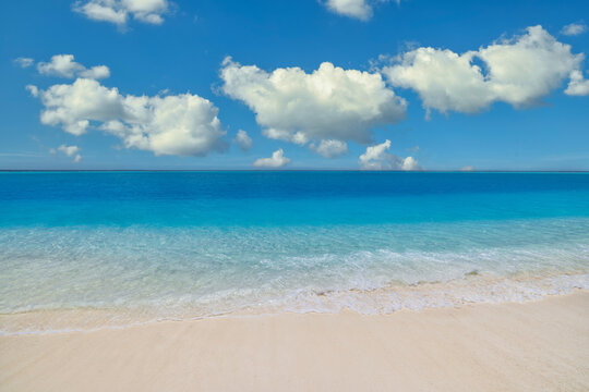 Minimal tropical seascape crystal turquoise water meeting bright horizon clean open sky simple summer calm. Peaceful empty beach travel scene. Relaxing wellness meditation coastal summer background