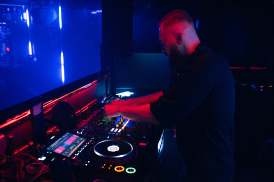 DJ Plays Music at Nightclub During Night