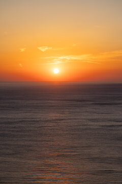 Serene golden sunset calm ocean glowing orange sun soft horizon minimal tropical sky evening summer sea. Peaceful summer sunset scene nature. Romantic relaxing meditation minimal coastal wellbeing