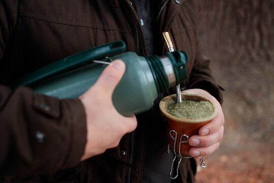 Pouring water into mate gourd