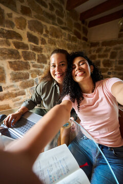 Women working online at home sharing moment