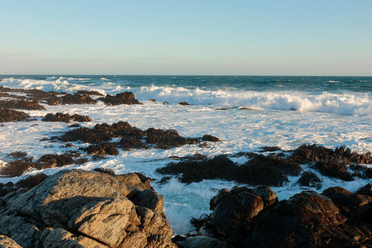 Ocean waves breaking against coastal rocks