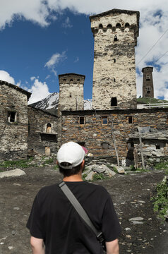 Traveler admiring medieval towers of Ushguli, Georgia