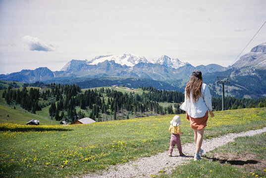 Mother and her little daughter hiking in the mountains