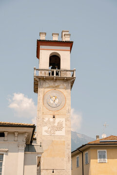 Historic clock tower in italian village square, Italy