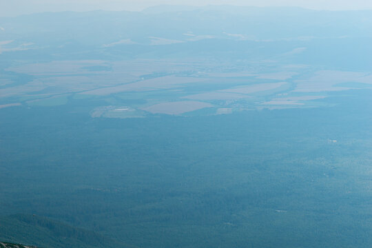 aerial view from lomnicky stit hazy valley fields forest slovakia high tatras mountain panorama blue tone misty landscape concept of nature, travel, tourism