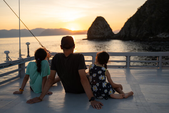 Family Enjoying Sunset on Boat Deck. Travel