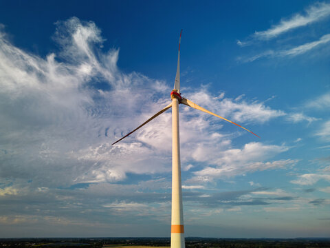 Wind Turbine Stands Tall Against the Sky at Sunset