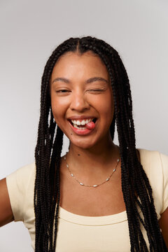 Young Woman Smiling and Playfully Winking at the Camera Indoors