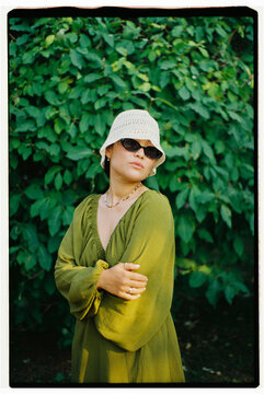 Portrait of Stylish Woman Wearing Bucket Hat Outdoors