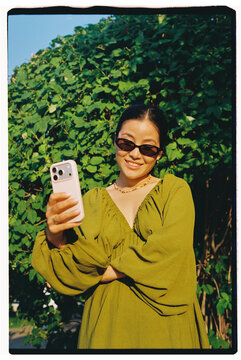 Portrait of Smiling Woman Taking a Selfie Outdoors