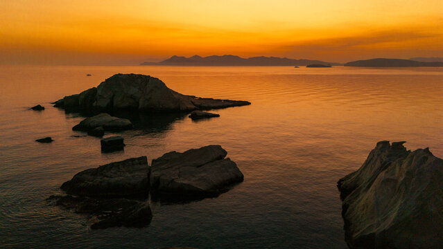 Quiet early pre dawn sunrise with colorful sky over Aegean Sea at Mandrakia village on Greek island Milos in Greece.