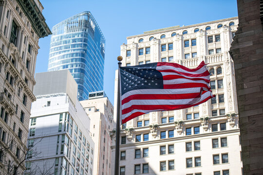 American flag waving low angle skyscraper New York USA