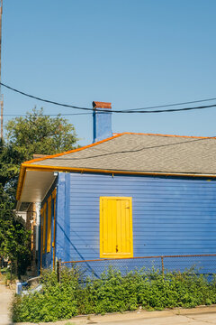 Blue house with yellow shutter in New Orleans