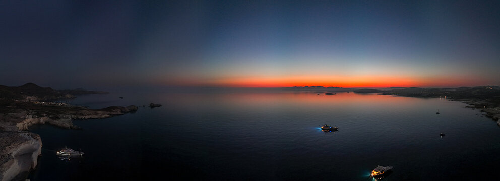 Quiet early pre dawn sunrise with colorful sky over Aegean Sea at Mandrakia village on Greek island Milos in Greece.