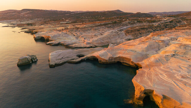 Quiet early pre dawn sunrise with colorful sky over Aegean Sea at Mandrakia village on Greek island Milos in Greece.
