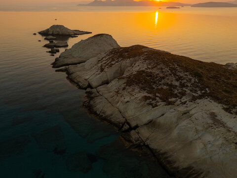 Quiet early pre dawn sunrise with colorful sky over Aegean Sea at Mandrakia village on Greek island Milos in Greece.