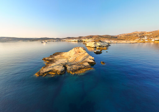 Quiet early pre dawn sunrise with colorful sky over Aegean Sea at Mandrakia village on Greek island Milos in Greece.