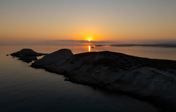 Quiet early pre dawn sunrise with colorful sky over Aegean Sea at Mandrakia village on Greek island Milos in Greece.