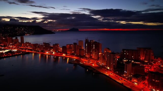 Nocturnal Bay Lit By Vibrant Lights, Neon Streets And Glowing Waterfront, Dramatic Cloudline And Deep Evening