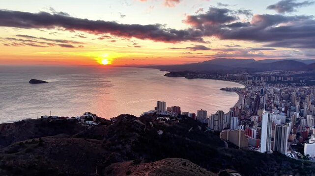 Sunrise From Hilltop Viewpoint Overlooking Bay And City, Warm Sun Breaking Through Clouds, Coastal Cliffs