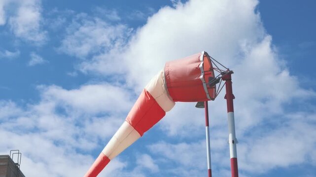 Orange and White Striped Airport Windsock Under Blue Sky