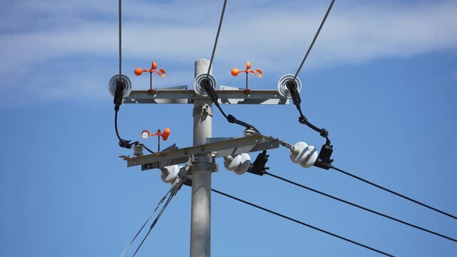 Electric power pole insulators against blue sky