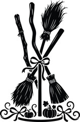 Fototapeta premium Festive black and white vector silhouette illustration of multiple crossed witch broomsticks tied with a ribbon for halloween decorations