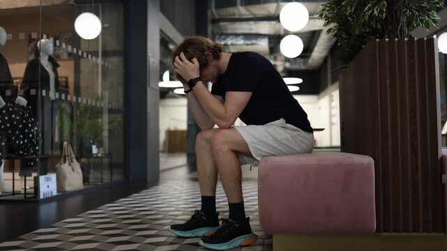 Lonely man sits by himself feeling isolated and lost in thought while reflecting on loneliness lack of connection and emotional distance during a quiet moment indoors now