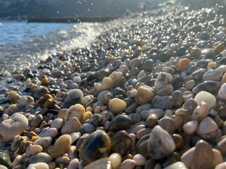close up of some colorfoul pebbles being hit by the waves at a beach in Baska, Croatia © Isabella