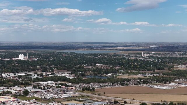 Aerial of suburban and agricultural landscape in Loveland Colorado in summer with residential areas and Lake Loveland