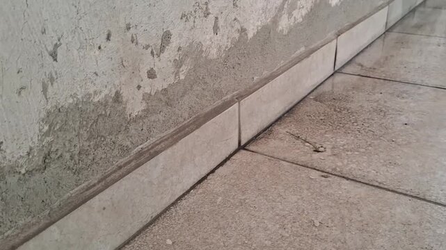 Wet floor tiles with pooling water