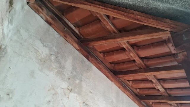 Wooden roof rafters construction video showing rustic clay tiles