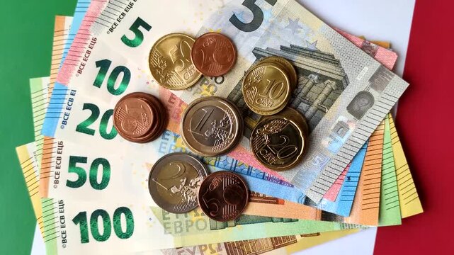 Italy, Italian euro cash and cent coins against the background of the flag. Euro cash against the Italian flag as a background for your design