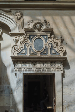 Ornate Renaissance stone doorway with cherub carvings on the exterior of Seville Cathedral