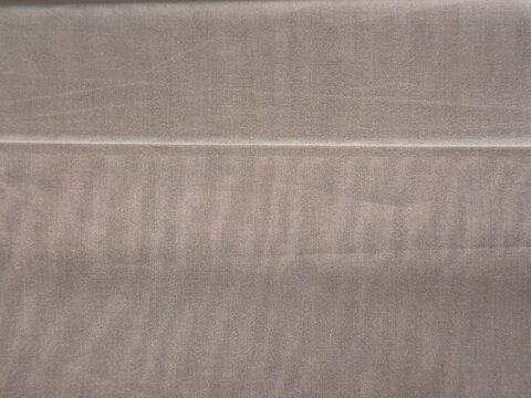 Warm taupe fabric texture with horizontal fold line