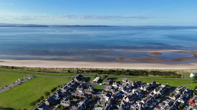 High wide aerial drone video of Nairn town center, , Nairn Beach, harbour, and Moray Firth in Nairnshire, Scottish Highlands, Scotland