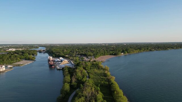 Moving back aerial of the Welland Canal and Sunset Beach in St. Catharines, Ontario, Canada. St. Lawrence Seaway and Great Lakes Waterway, connecting Lake Ontario to Lake Erie. May, 2023.