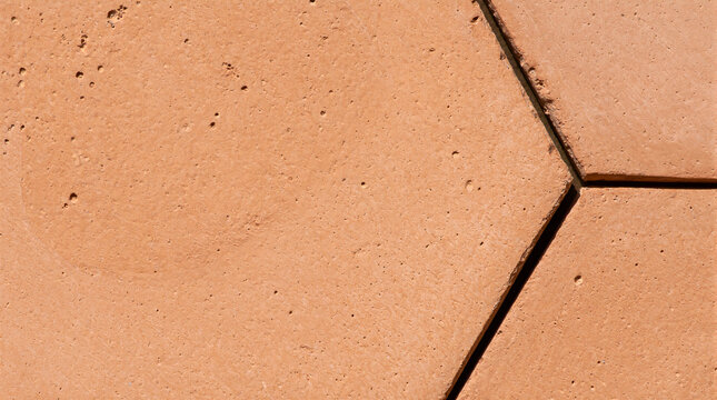 Natural handmade unglazed terracotta hex tile detail featuring subtle surface pitting and clay variation