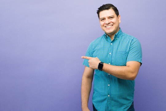 Man pointing left, recommending advertisement, offering promotion, presenting choice, showing important information