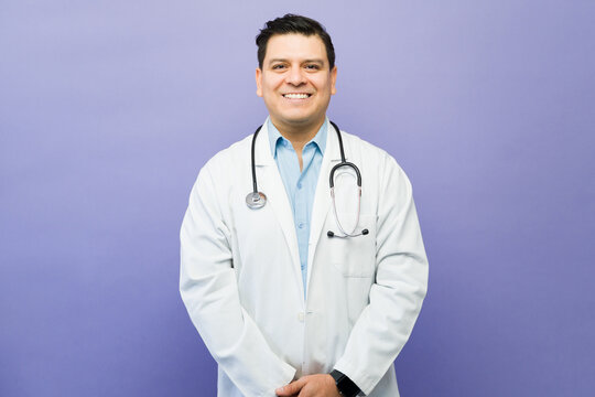Smiling male physician wearing a lab coat and stethoscope, representing healthcare, medicine, and professionalism