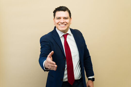 Businessman offering handshake, greeting partner, welcoming client, starting a new business deal