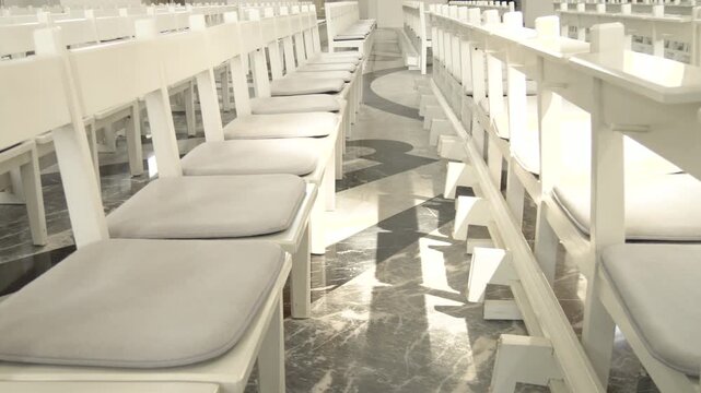 Rows of Empty White Pews in Church