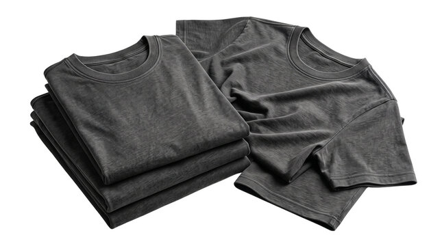 Stack of dark t-shirts neatly folded and placed beside an unfolded shirt.
