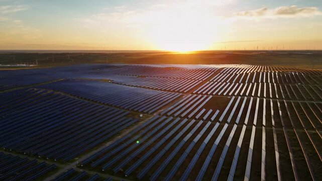 Aerial view of solar panel array at sunset