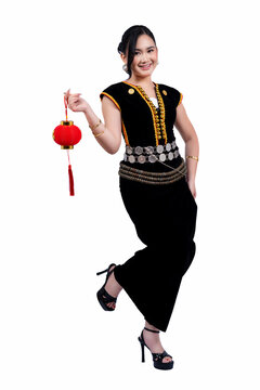 Young women in Kadazan Dusun traditional clothing holding a red Chinese lantern white background
