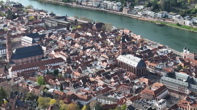 heidelberg old town rooftops church of the holy spirit jesuit church tower old bridge stone arches spanning neckar river baden wurttemberg germany aerial view drone footage historic heritage site