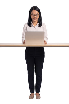Businesswoman Standing at Desk Typing on Laptop
