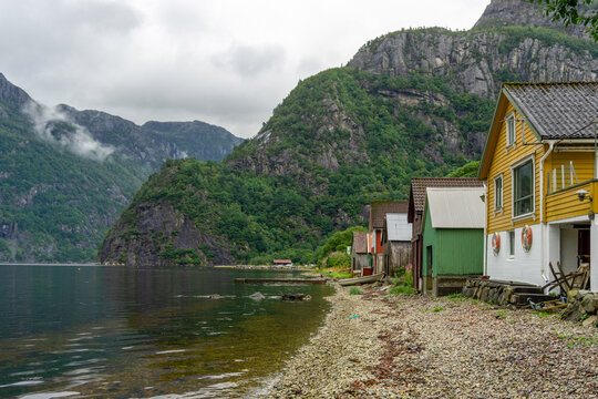Colorful boathouses lining Dirdal fjord in Norway