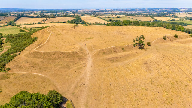 An aerial view above the remains of the Burrough Hill Iron Age Hillfort in rural Leicestershire, UK after a long dry summer